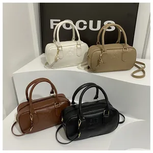 Detail showing four Boston handbags in white, khaki, brown and black with matte PU texture