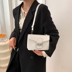 Fashionable beige crossbody bag with woven texture shown on a minimalist model set