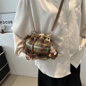 Retro plaid bucket bag with drawstring closure and cute plush monster pendant for women