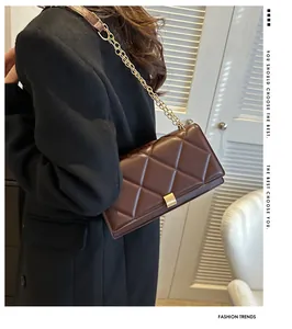Close-up of deep brown quilted leather bag featuring a gold chain strap and metal buckle