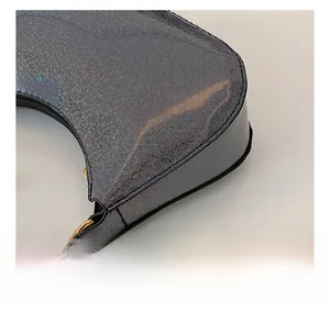Detail shot of iridescent mesh texture and gold chain on silver shoulder bag