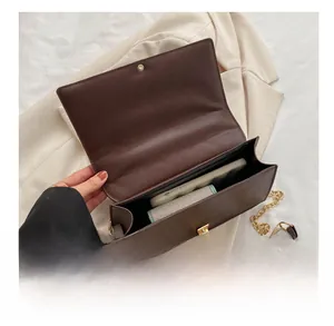 Macro shot of dark brown crossbody bag interior showing phone and wallet storage