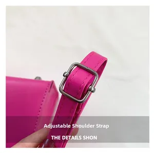Close-up of the adjustable shoulder strap with silver buckle on a rose pink handbag