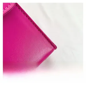 Close-up of premium rose red leather bag with precise stitching and fine texture details