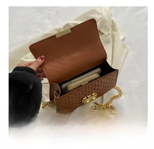 Interior view of the brown quilted crossbody bag showing spacious capacity for phone and wallet
