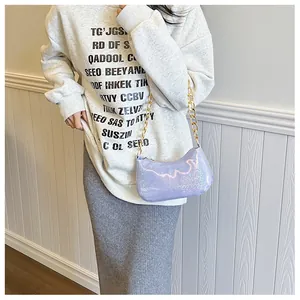 Close-up of holographic lavender shoulder bag featuring a chunky gold metal chain strap