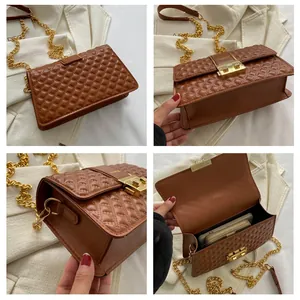 Detail view of brown quilted crossbody bag with gold chain and interior storage