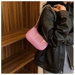 Detail of pink sequin shoulder bag with premium chunky gold chain strap for women