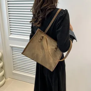 Retro brown large capacity tote bag with marble texture and rivet detail on shoulder strap