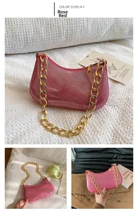 Detail of rose red sequined shoulder bag with chunky gold chain strap and zipper
