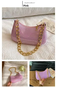 Close-up of pink sequined crescent bag with chunky gold chain strap and chic design