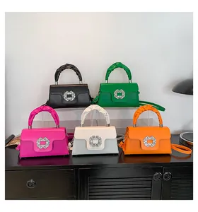 Detail of colorful square handbags with rhinestone buckles and pleated top handles