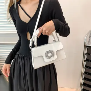 Elegant white crossbody bag with sparkling square rhinestone buckle and ruched handle