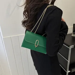 Minimalist green rectangle crossbody bag with gold chain and white contrast stitching
