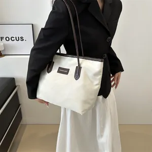 Large capacity oxford tote bag in cream white and dark brown trim worn by a model