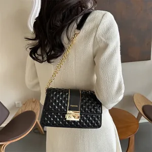 Black quilted crossbody bag with gold chain and metal studs for a chic style