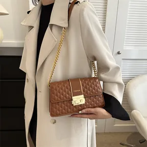 Elegant caramel quilted chain shoulder bag featuring a gold buckle and fashion design