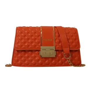 Bright orange quilted crossbody bag with gold chain strap and fashion clasp detail