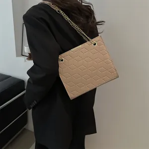 Minimalist khaki shoulder bag with 3D geometric embossed pattern and gold chain strap