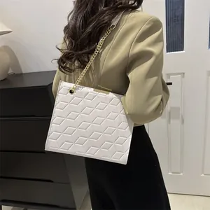 Chic white crossbody bag with geometric quilted texture and gold chain strap for women