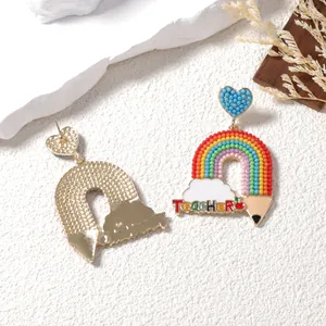 Rainbow beaded earrings with heart studs and Teacher text on artistic background
