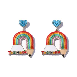 Rainbow teacher earrings with heart bead, pencil, and apple charms on white background