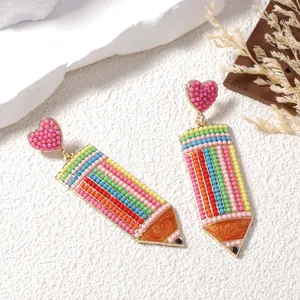 Colorful beaded pencil earrings with a pink heart stud and creative handmade design