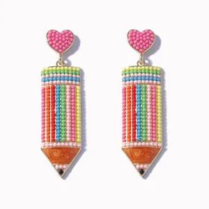 Colorful beaded pencil earrings with pink heart studs on a clean white background