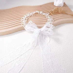 Elegant white lace choker with pearls and long ribbon bow for wedding bridal fashion