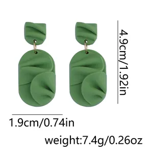 Detailed view of handmade green clay earrings with petal texture and size dimensions