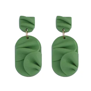 Elegant green geometric petal earrings with textured matte finish and gold metal rings