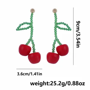 Detail showing dimensions of red beaded cherry earrings with measurements 9cm by 3.6cm