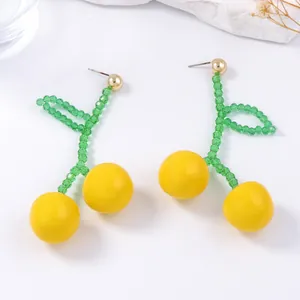 Handmade beaded cherry drop earrings with yellow resin fruits and green beaded leaves