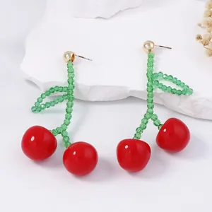 Handmade beaded cherry drop earrings with vibrant red fruit and green crystal leaves