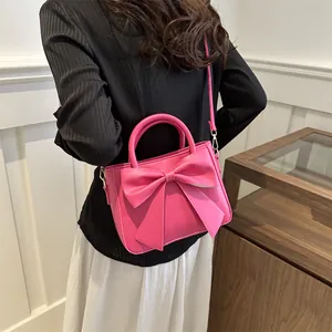 Fashionable rose pink handbag with bow design and adjustable shoulder strap for women