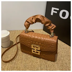 Detailed macro view of retro brown crocodile pattern PU leather with a golden geometric lock