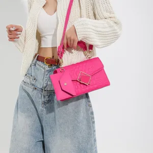 Magenta pleated shoulder bag with crocodile texture and silk-wrapped handle on a model