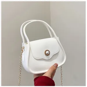 Detail of white jelly mini bag with glossy finish and pearl gold buckle feature