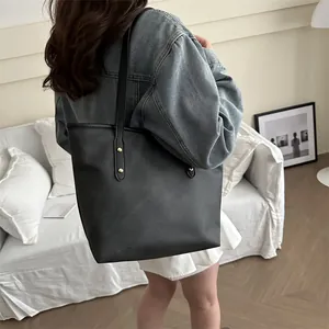 Minimalist large black faux leather tote bag for women with gold rivet details