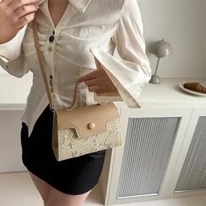 Chic woven handbag with floral embroidery and creamy leather flap on elegant indoor table