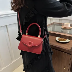 Fashionable red square mini handbag for women with round buckle and golden hardware details