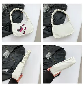 Multiple views of a white butterfly print shoulder bag with stylish ruched cloud straps