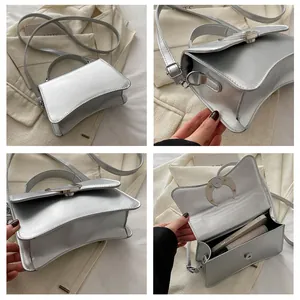Détails du sac trapèze argenté avec boucle métallique en croissant et bandoulière réglable