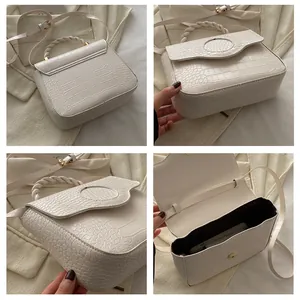 Detail view showing textured cream handbag with woven handle, strap, and interior layout