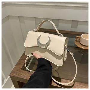 Détail du sac en cuir PU blanc crème avec texture litchi et boucle en métal argenté