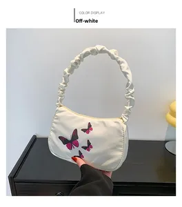 Close-up of off-white butterfly print handbag with a trendy gathered ruched handle