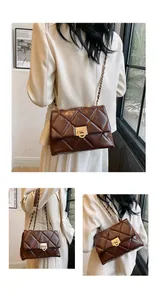 Detail of dark brown quilted crossbody bag with gold twist lock and metal chain strap