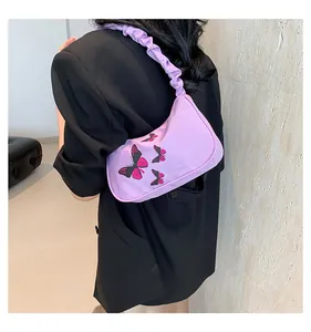 Detail of purple butterfly print baguette bag with trendy ruched cloud shoulder strap