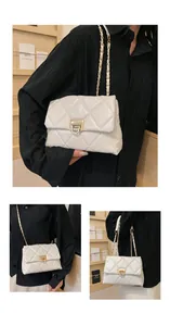 Close-up of white quilted chain bag with gold metal D-ring twist lock detail