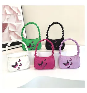 Detail showing various colors of butterfly printed shoulder bags with ruffled handles